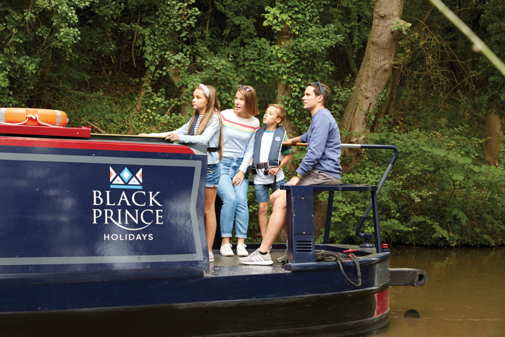 Black Prince Narrowboat holidays - family with lifejackets drive boat
